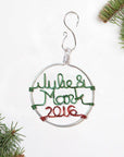 Personalized couple's Christmas ornament in silver outline that says Julie & Mark in green aluminum wire and 2016 in red aluminum wire.