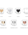 Personalized glass mugs, image shows 7 clear mugs persoanlized with hearts of different colors showing the options in which they can be personalized. The colors are: gold, silver,black,white, mirrored gold, mirrored silver and mirrorred rose gold.