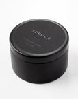 Spruce natural soy candle in its black tin container with black label and white lettering featured.
