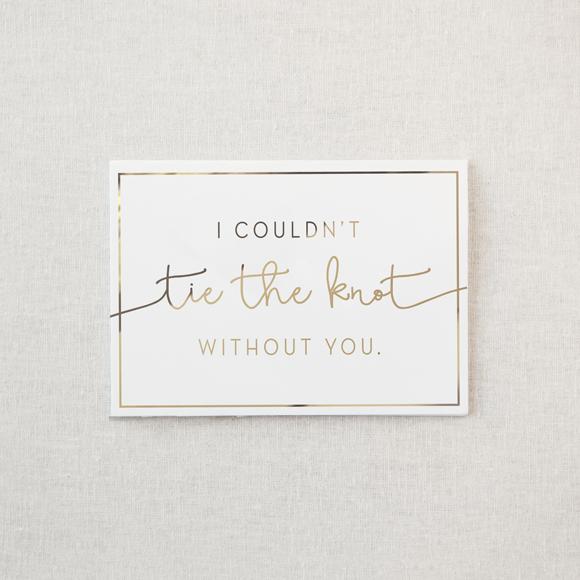 White greeting card. Reads "I couldn't tie the knot without you" in gold lettering
