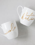 A personalized white coffee mug can be personalized in different colors.