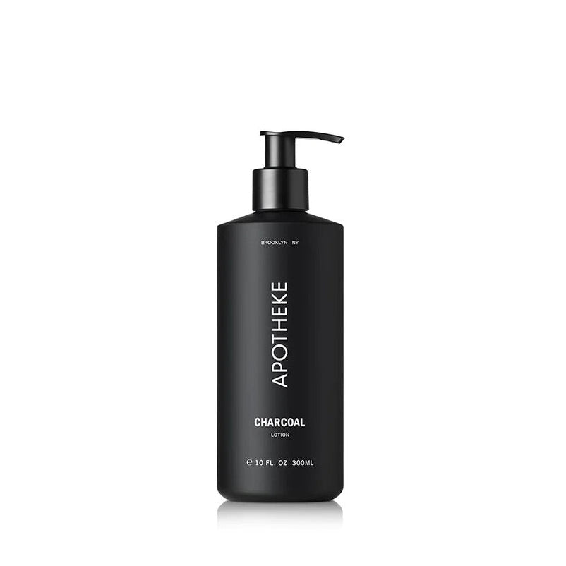 Apotheke Charcoal Body Lotion in a sleek matte black container with crisp white lettering, displayed on a clean white background.