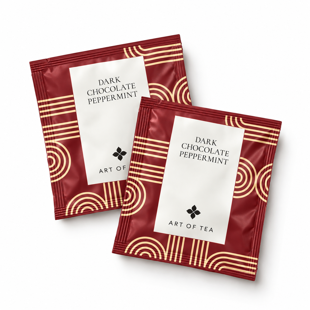 Two Art of Tea Dark Chocolate Peppermint tea bags in red and gold foil packaging, arranged on a clean white background.