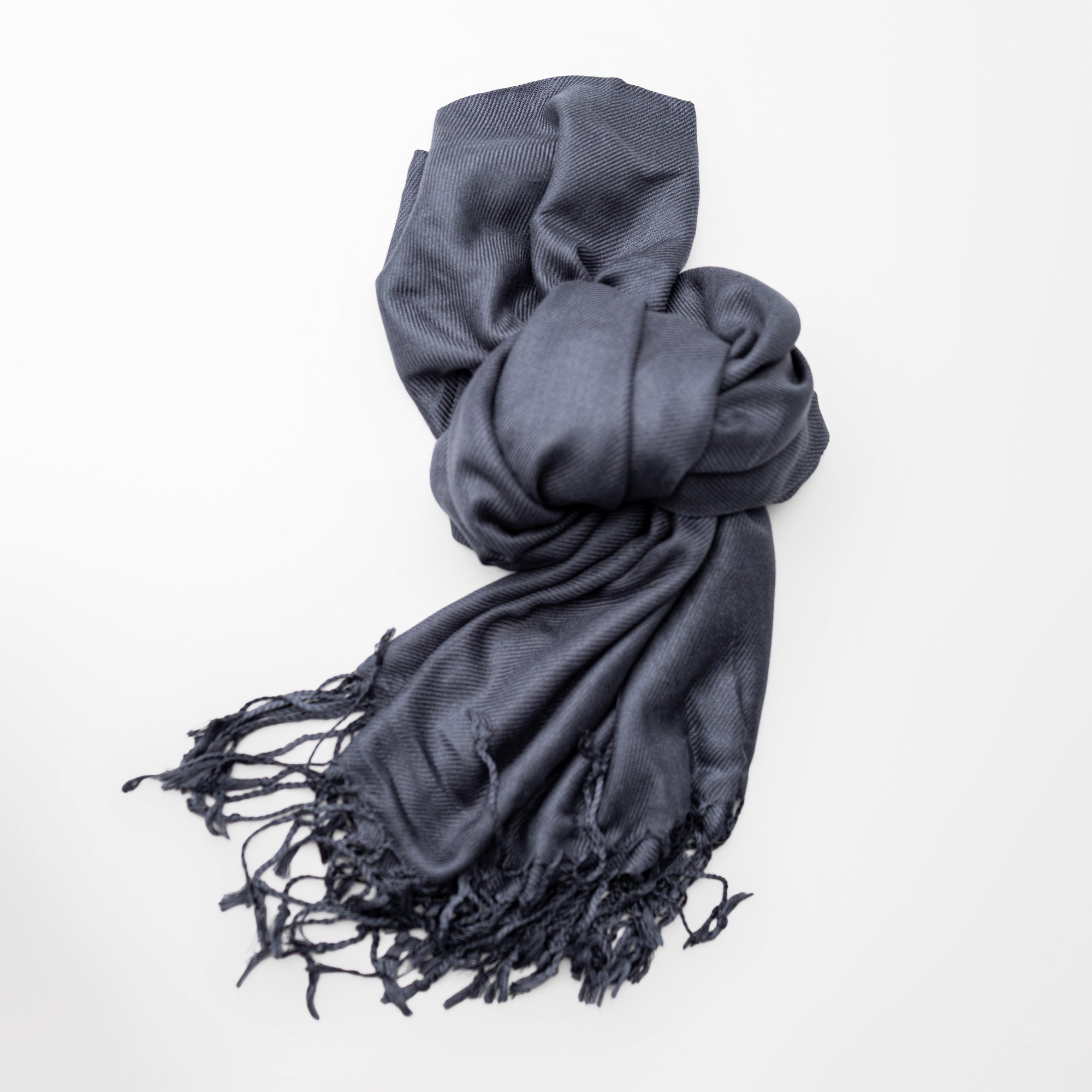 Ash grey pashmina with fringed edges on a white background.