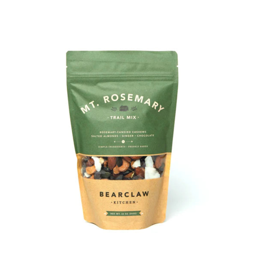 Pouch of Bearclaw Kitchen Mt. Rosemary Trail Mix on a white background, showing a rustic snack mix of rosemary-candied cashews, almonds, cranberries, chocolate chunks, coconut flakes, and ginger, packaged in a resealable kraft-style bag for gourmet snacking.