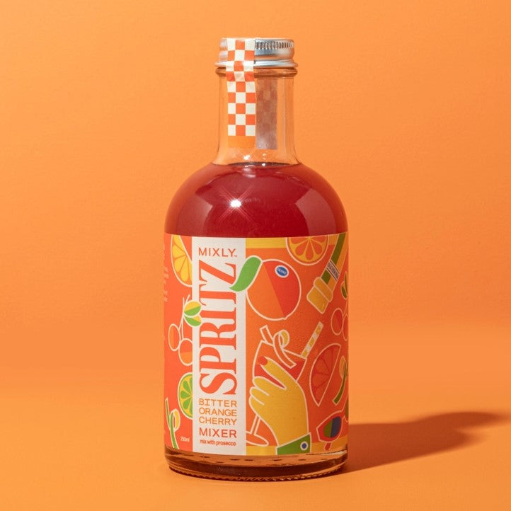 Bitter Orange Cherry spritz mix is featured in its transparent bottle showing the orange liquid with silver lid and orange label with yellow and orange graphics in an orange background.