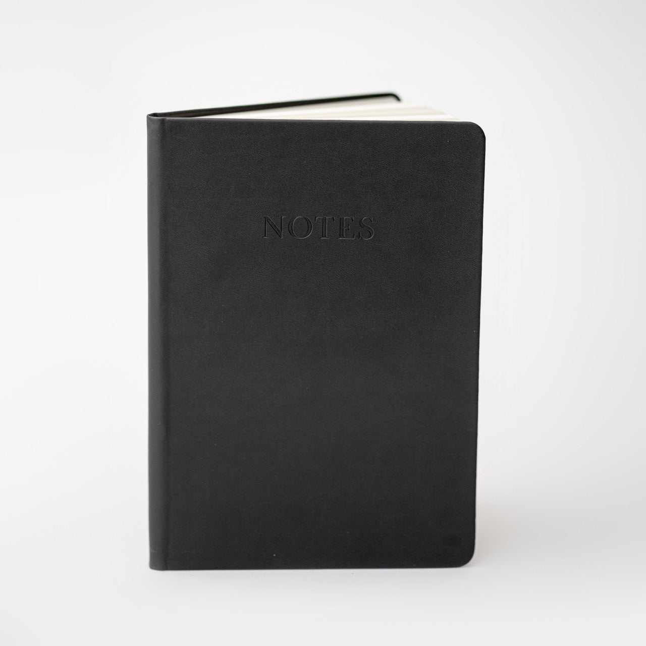 Black pocket notebook on white background.