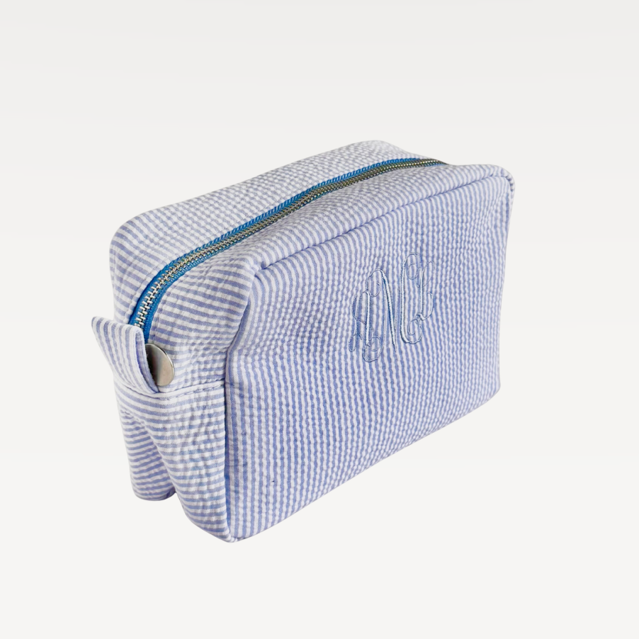 Blue and white striped rectangular makeup bag with zipper closure.