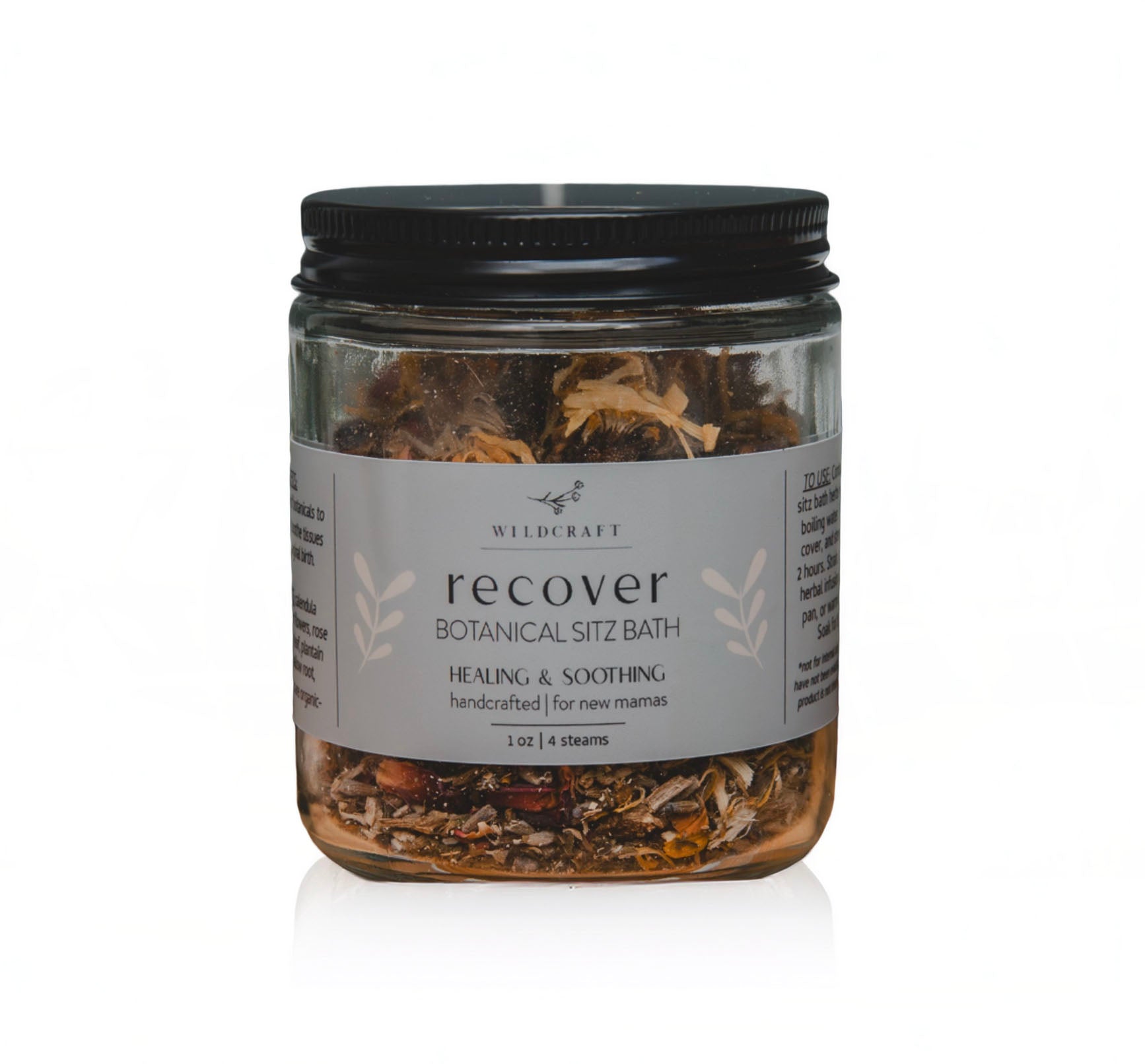 Jar of 'recover' botanical sitz bath with a black lid on a white background