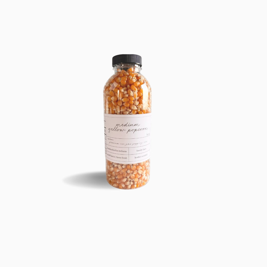 Image of bottled yellow popcorn on a white background. 