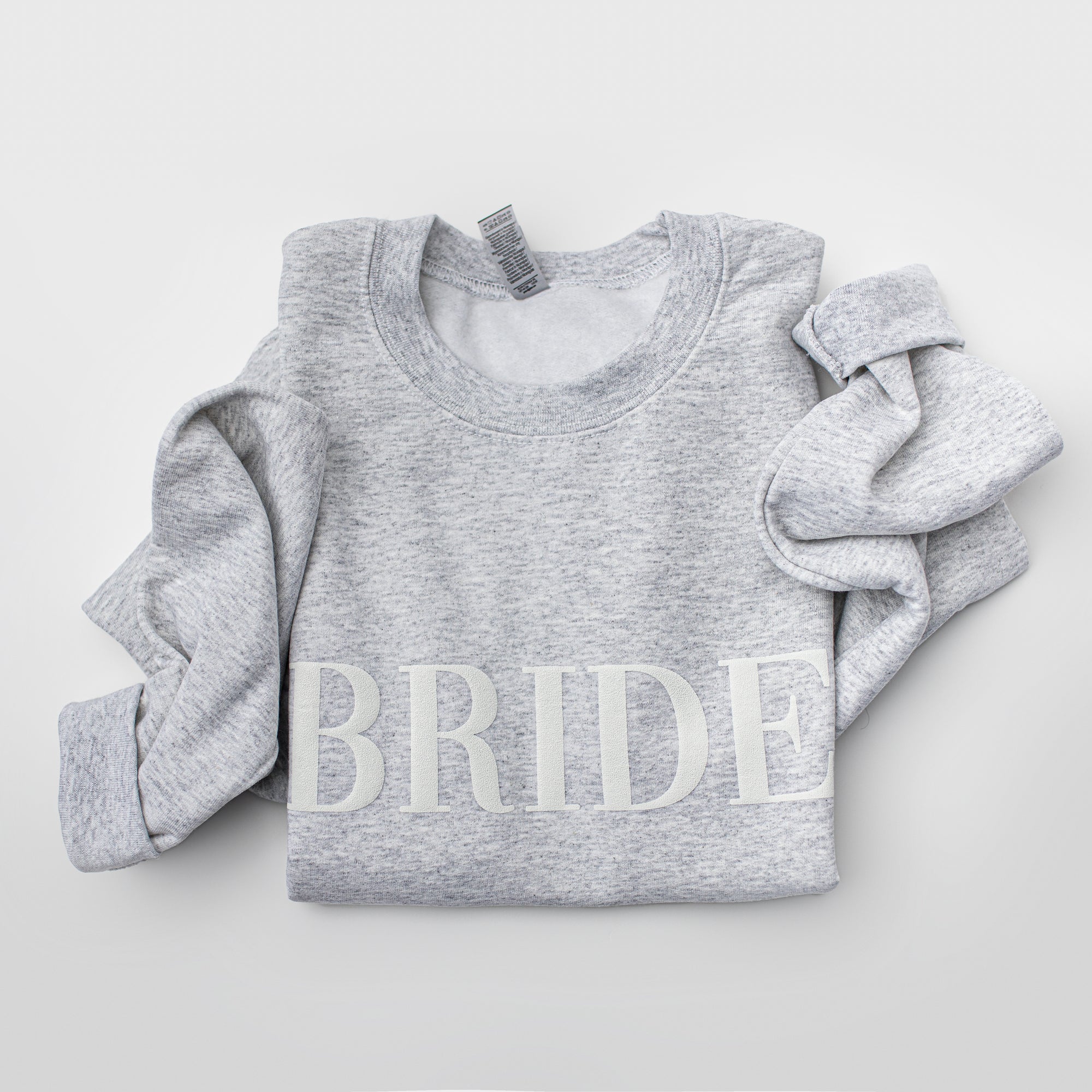 Folded army gray crewneck sweatshirt with large white-embroidered “BRIDE” lettering across the chest on a plain white background.