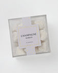 Box of 'Champagne Bubbles' with a decorative tag on a light gray background