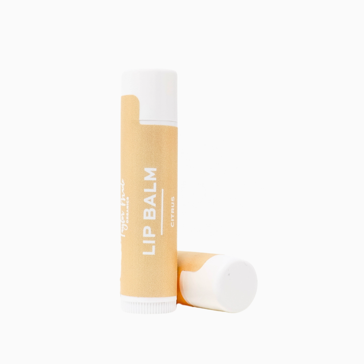 Lip balm with a white cap and yellow label on a white background