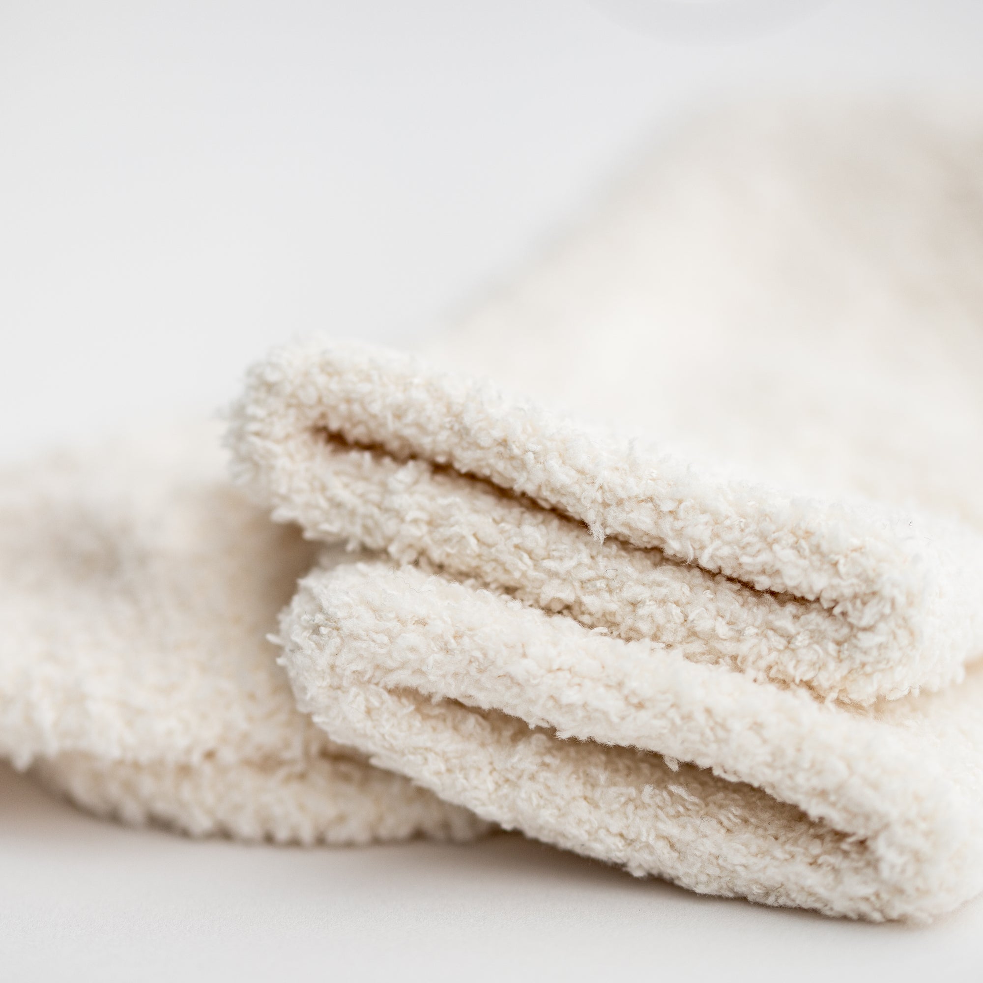  Close up image of our signature cloud socks are ivory in color on a white background shown.