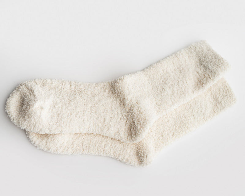 Our signature cloud socks are ivory in color opened on a white background shown.