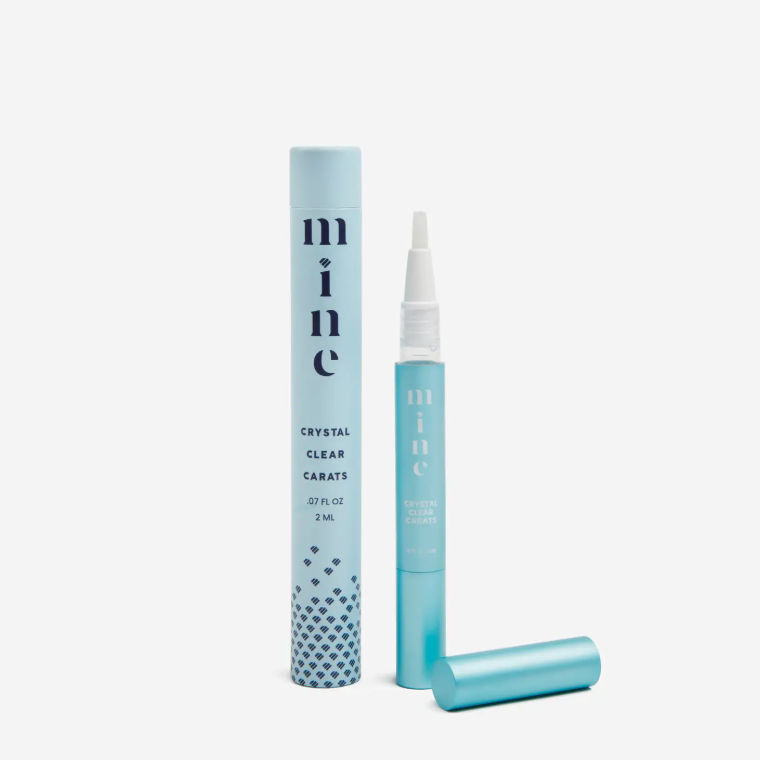 Blue cosmetic bottle and packaging with 'mine' branding on a white background
