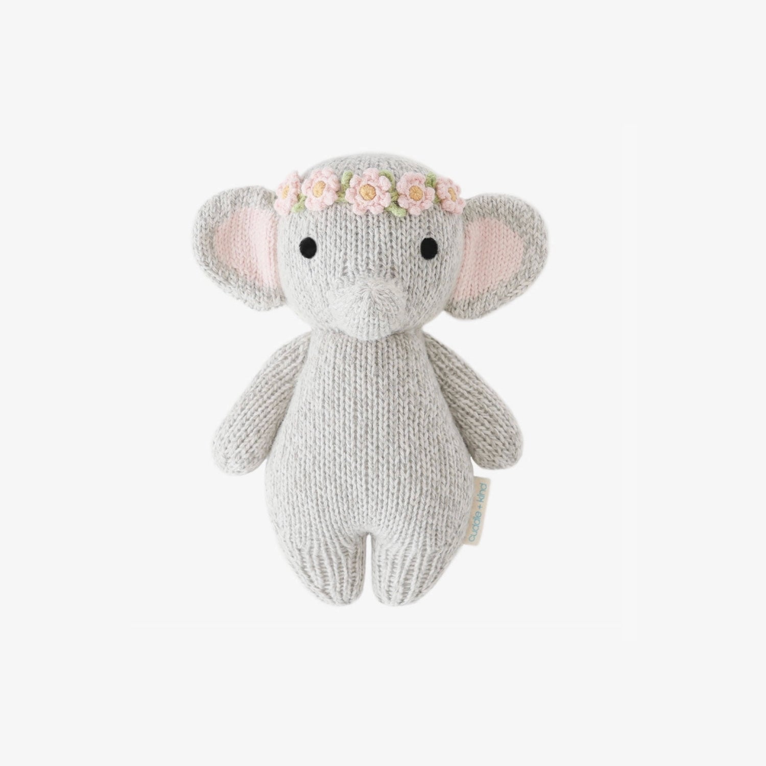 Handcrafted Cuddle + Kind Baby Elephant plush in soft grey knit fabric, sitting upright on a clean white background, featuring large floppy ears, stitched facial details, and a cozy handmade texture.