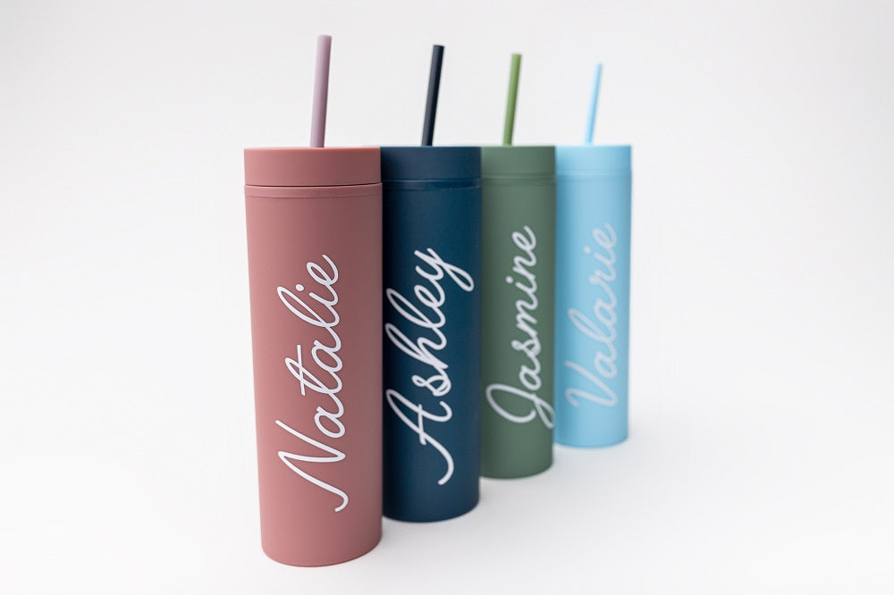 Our custom tumblers with straw shown in the four colors they come light blue, navy, green and rose. Personalized in white lettering with the names Valerie, Ashley, Jasmine and Natalie on a white background.  