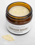 Dandelions naturals unscented tallow balm opened in its amber container on a white background. 
