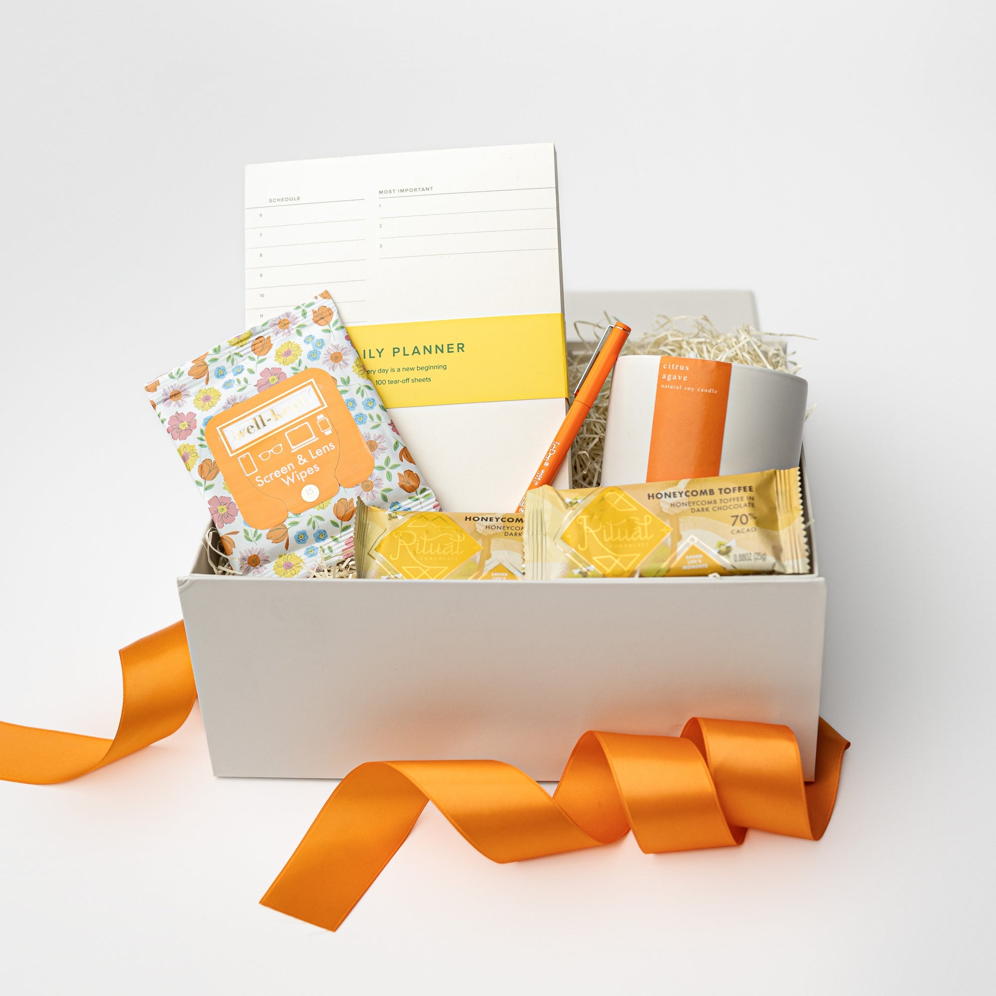 Gift box with stationery items on a white background