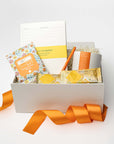 Gift box with stationery items on a white background
