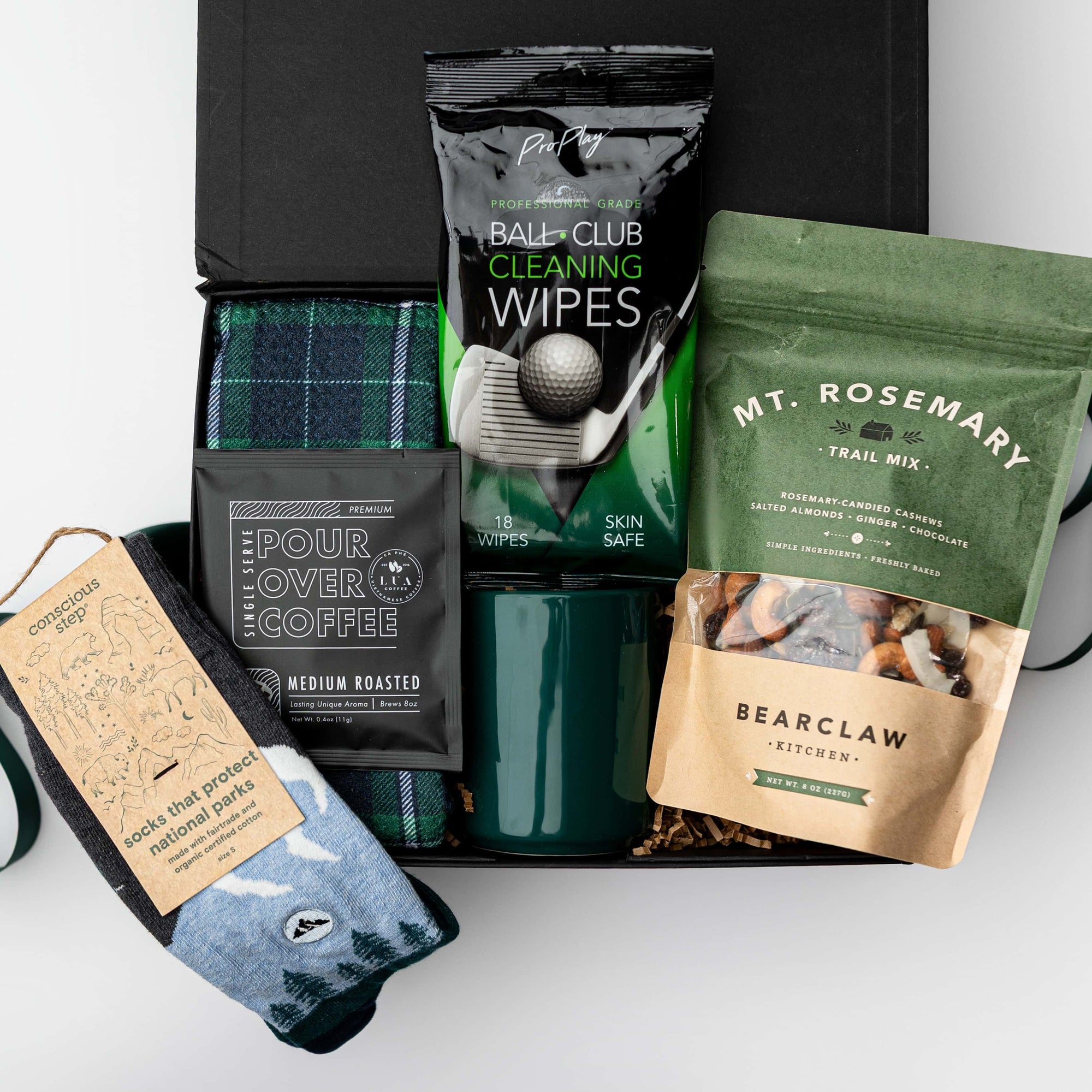 Gift box with coffee, tea, cleaning wipes, and socks on a white background