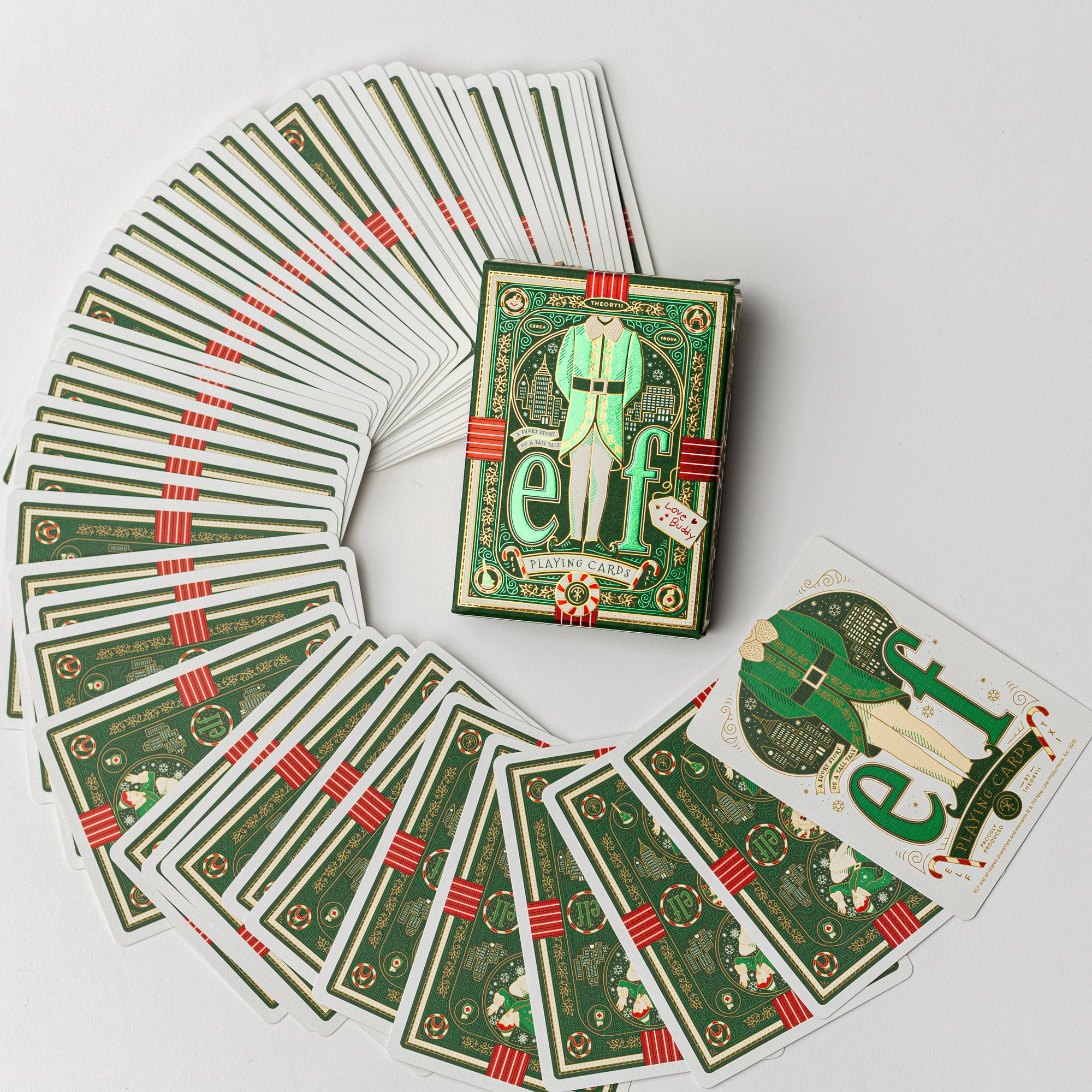 This overhead shot displays a deck of "Elf" themed playing cards, both fanned out and in their original box, set against a clean, white background, conveying a festive, thematic design.