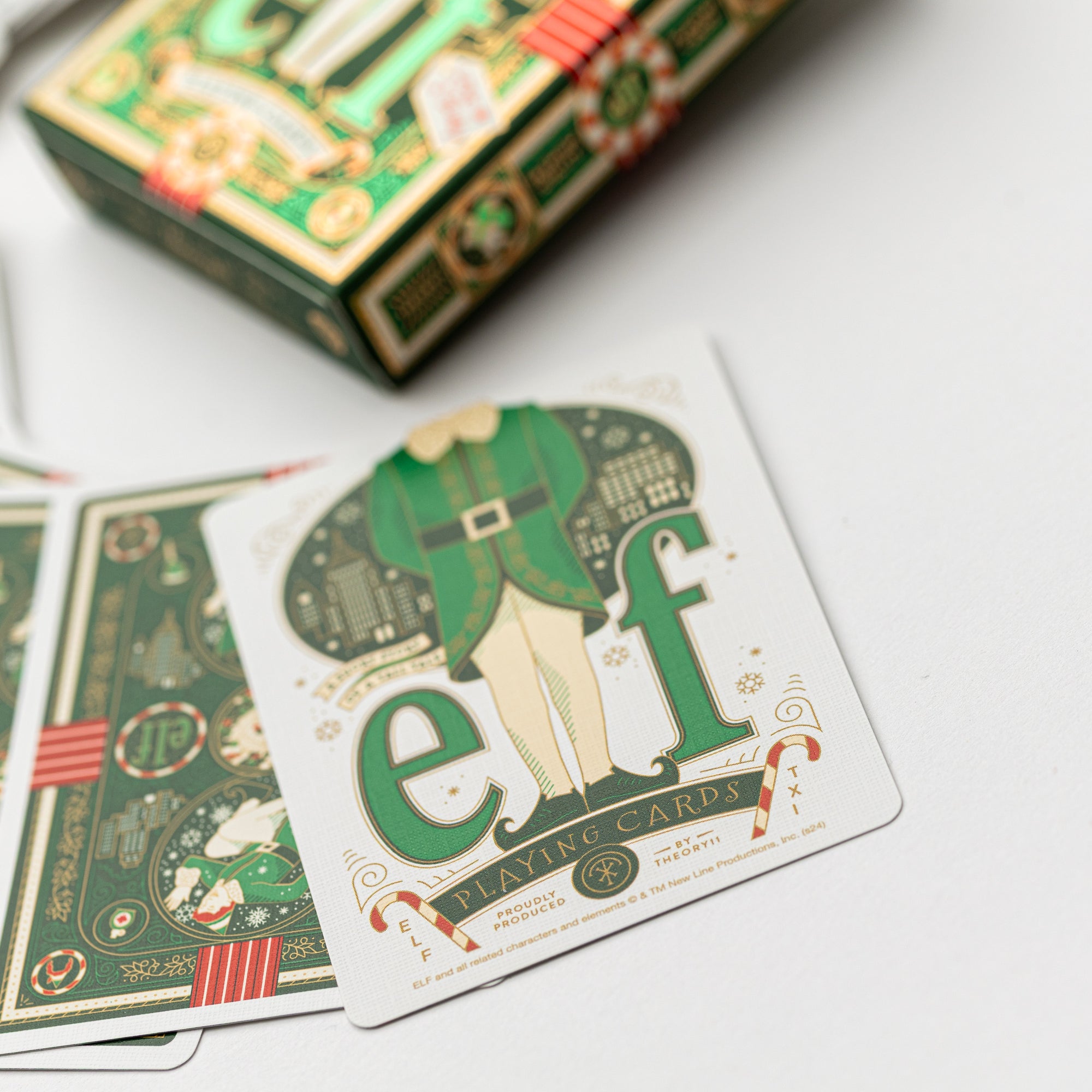 Close up image of elf luxury playing cards showing the elf card with white green and gold colors.
