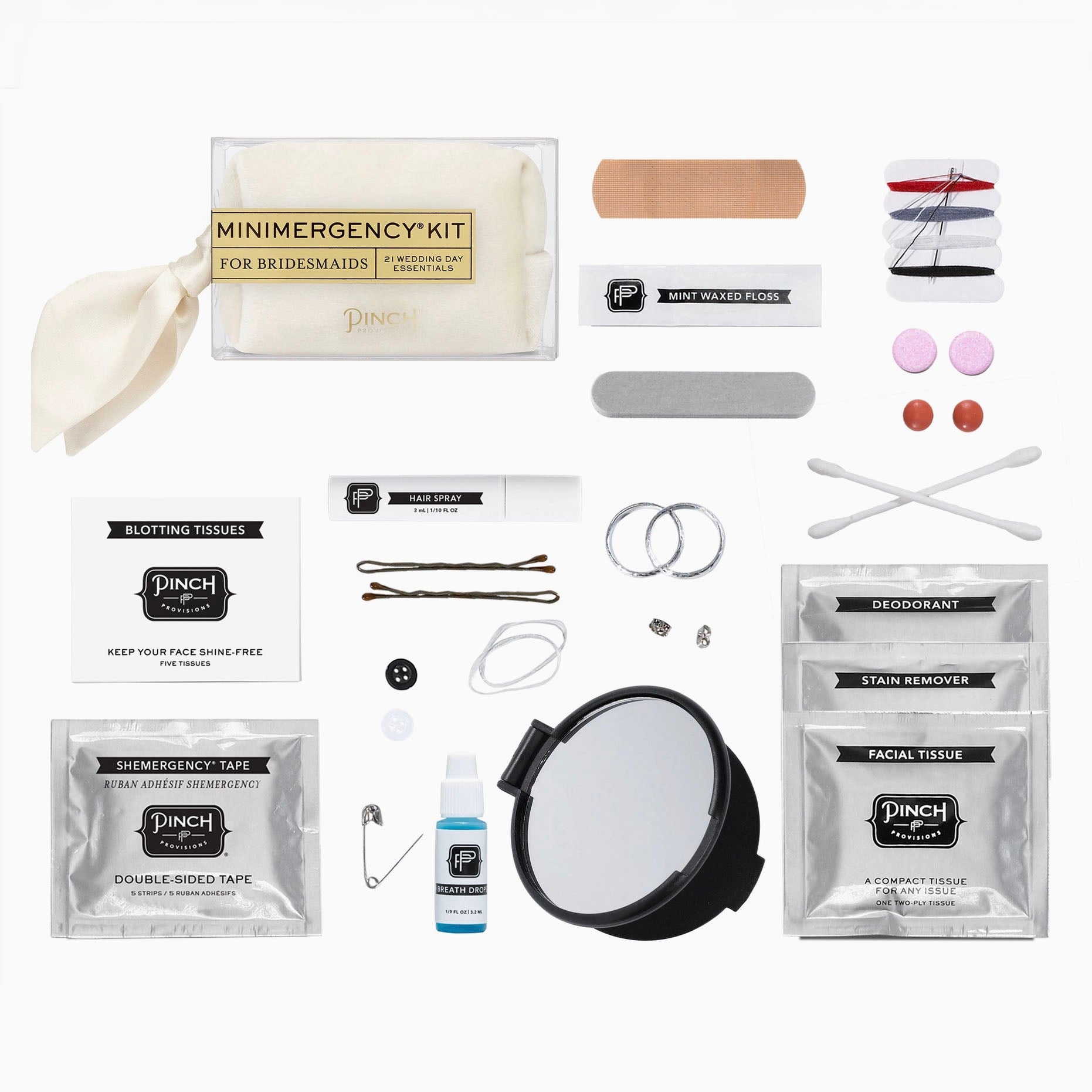 A bridal emergency makeup kit laid out on a white background, including a mini mirror, bandages, bobby pins, cotton swabs, double-sided tape, stain remover, deodorant, and a small bottle of liquid.