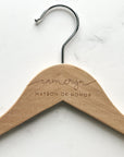 Engraved bride hanger is featured in natural personalized with Cameryn matron of honor in a marble-like background.