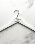 Engraved bride hanger on white personalized Alyssa bridesmaid on a marble like background. 