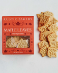 Rustic Bakery Maple Leaves sugar cookies shown next to their red packaging box on a white background.