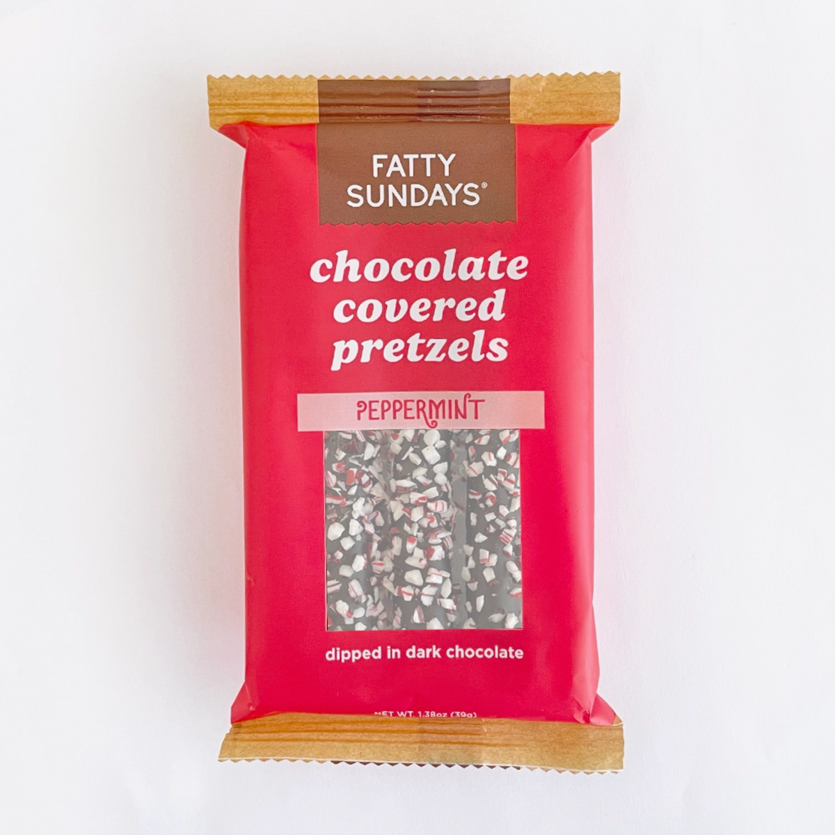 A single packaged snack bar of Fatty Sundays Chocolate Covered Pretzels in Peppermint flavor, featuring a bright red wrapper with a clear window showing the pretzel pieces coated in peppermint and dark chocolate.