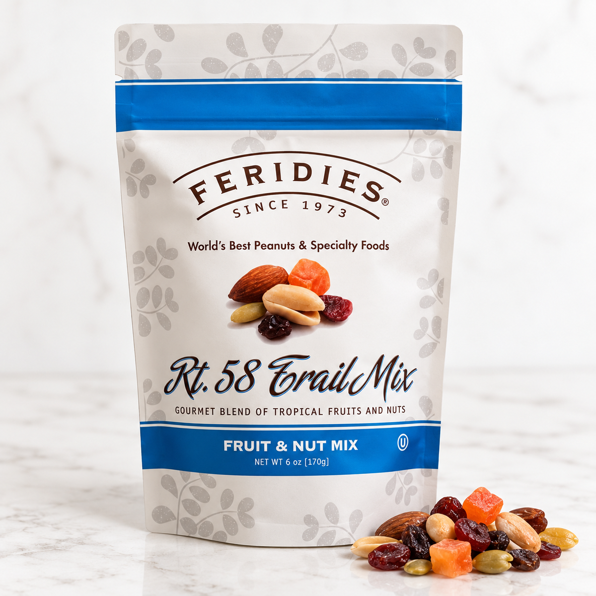 A stand-up pouch of Feridies Rt. 58 Trail Mix fruit and nut mix, shown on a light marble surface with some of the mixed nuts and dried fruit spilled in front.