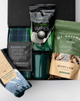Gift box with coffee, tea, cleaning wipes, and socks on a white background