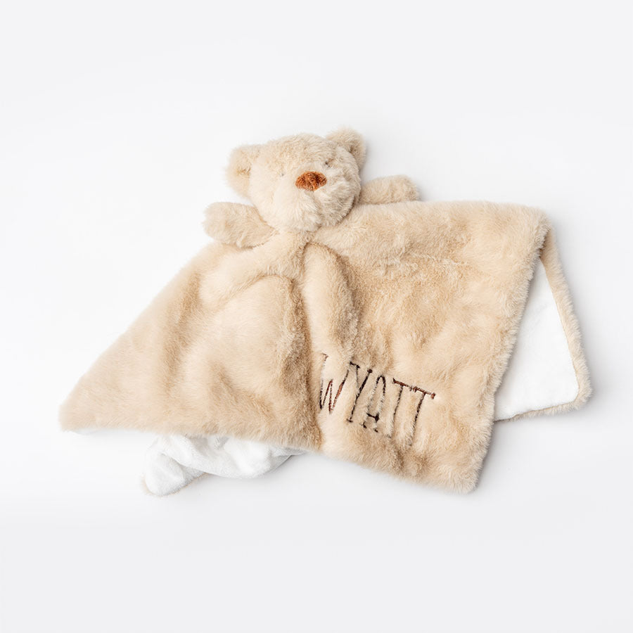 Light brown plush blanket with teddy bear shape and 'Wyatt' embroidery on a white background