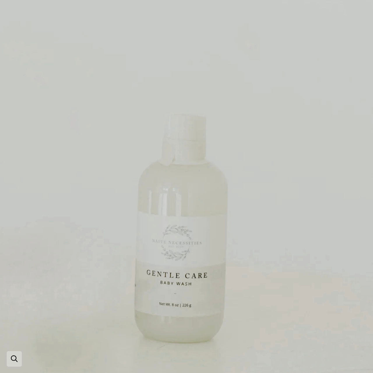 Bottle of 'Gentle Care' baby wash on a light gray background