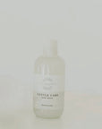 Bottle of 'Gentle Care' baby wash on a light gray background