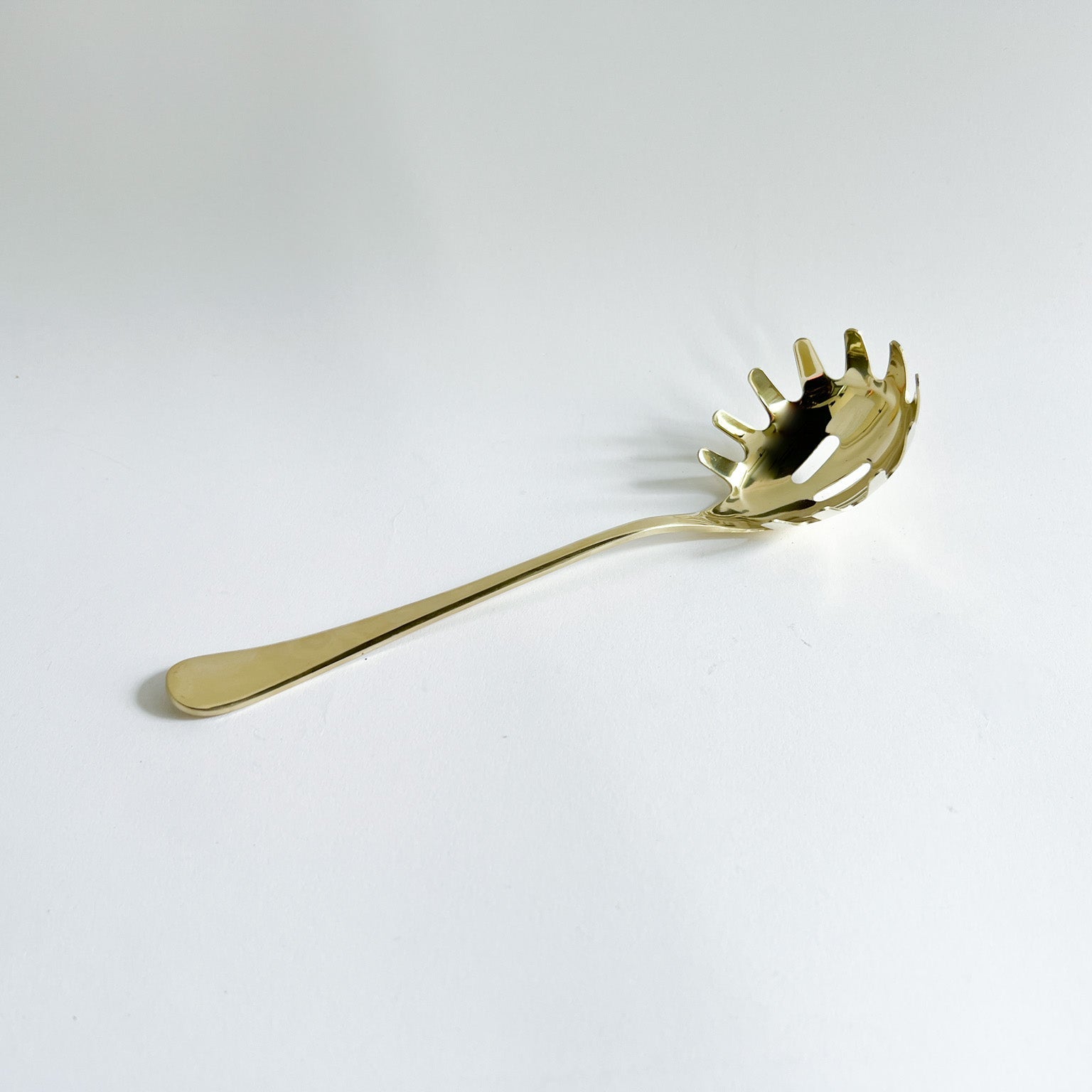 Gold Pasta Serving Spoon, the image shows the pasta serving spoon in a white background.