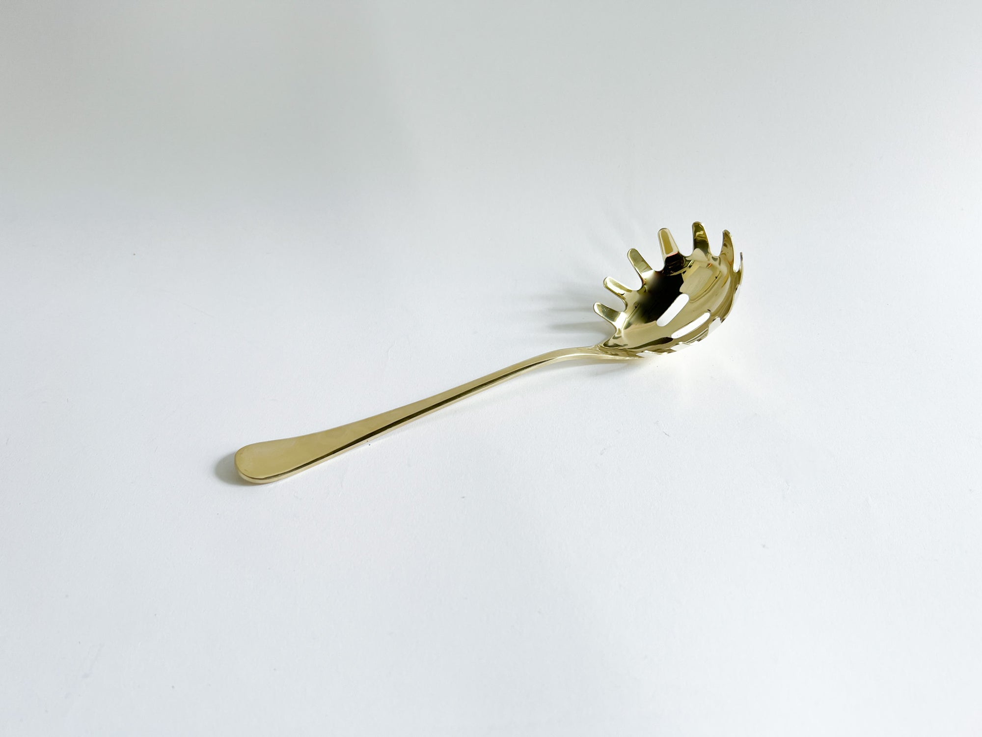 Gold Pasta Serving Spoon, the image shows the pasta serving spoon in a white background.