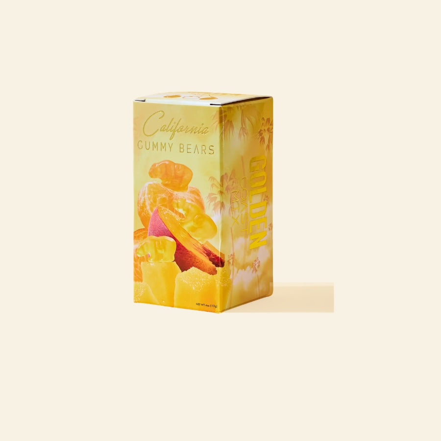 yellow box of tropical fruits gummy bears on a cream background
