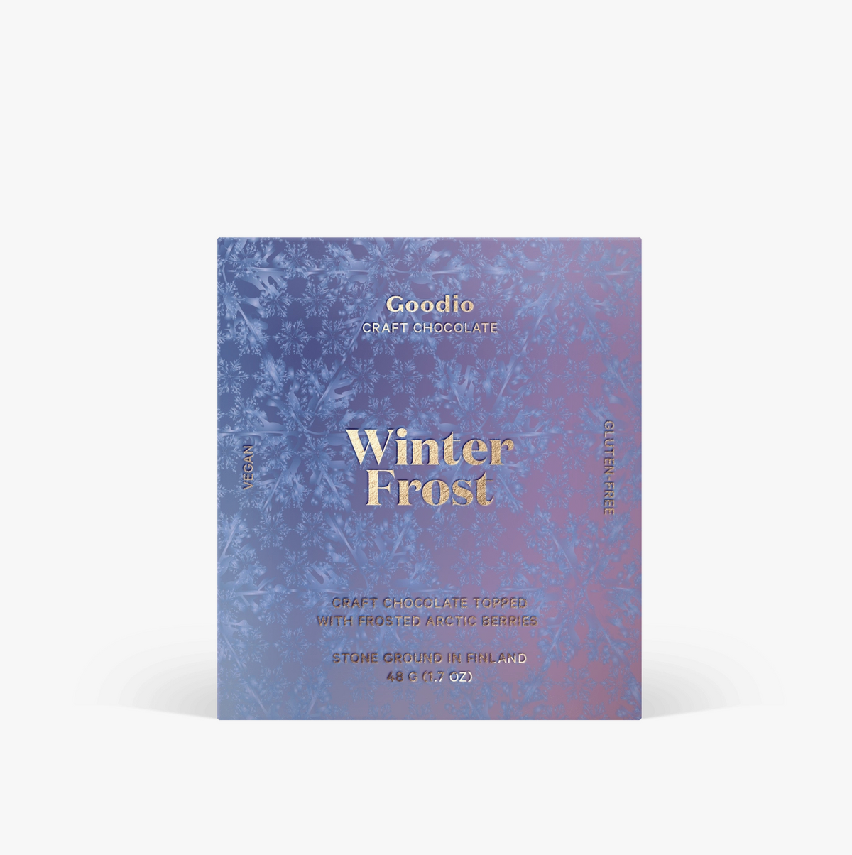 A square chocolate box labeled 'Winter Frost' by Goodio, featuring a blue and purple marbled design with gold text, shown on a light gray background.