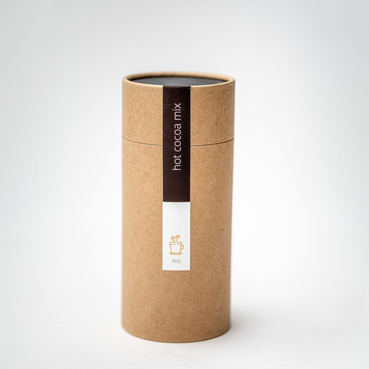 A cylindrical kraft paper tube package for hot cocoa mix, featuring a dark brown vertical label with white text and a white lower label with a small cocoa cup icon, set against a clean white background.