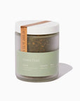 Green tea jar with a white lid on a white background