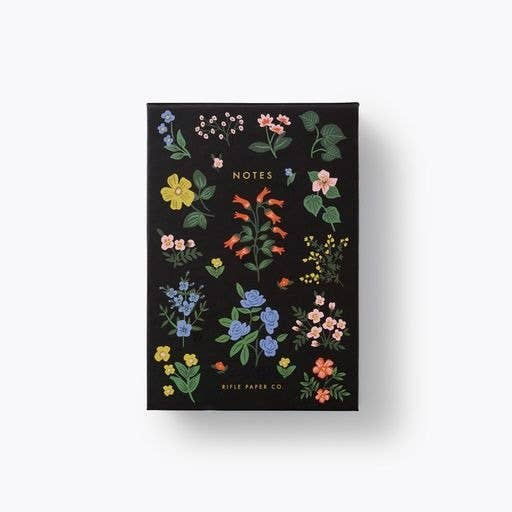 Hawthorne desktop notepad is featured black with floral design notes and riffle paper co in gold lettering on a white background. 