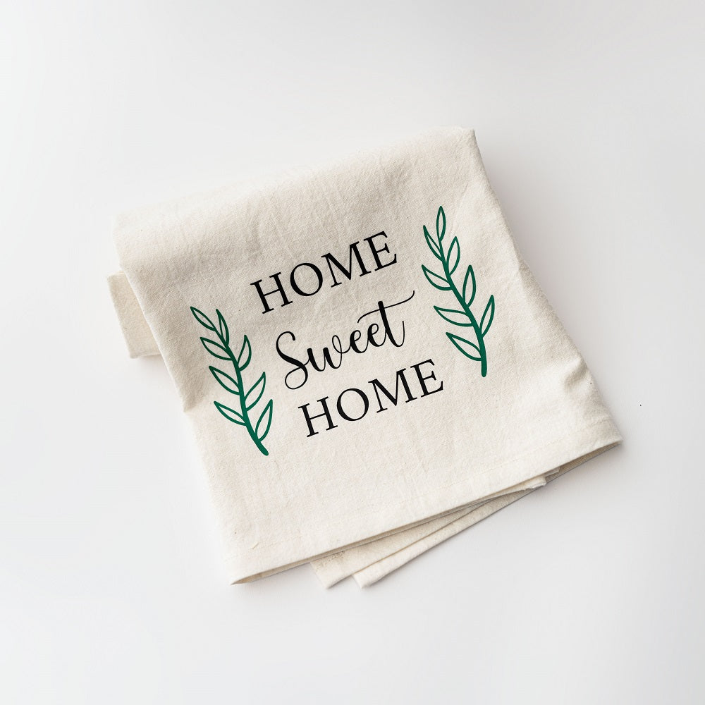 Home sweet home white towel featured has Home sweet home in black lettering with one green branch on each side on a white background.   