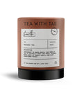 A product image of a container of Rooibos tea, featuring the tea name "honella" and various details about the tea from the brand Tea with Tae.  a close-up, full shot of a cylindrical container, which is the primary focus. The container is a light reddish-brown color, and a dark black base. Presented on a plain, white background