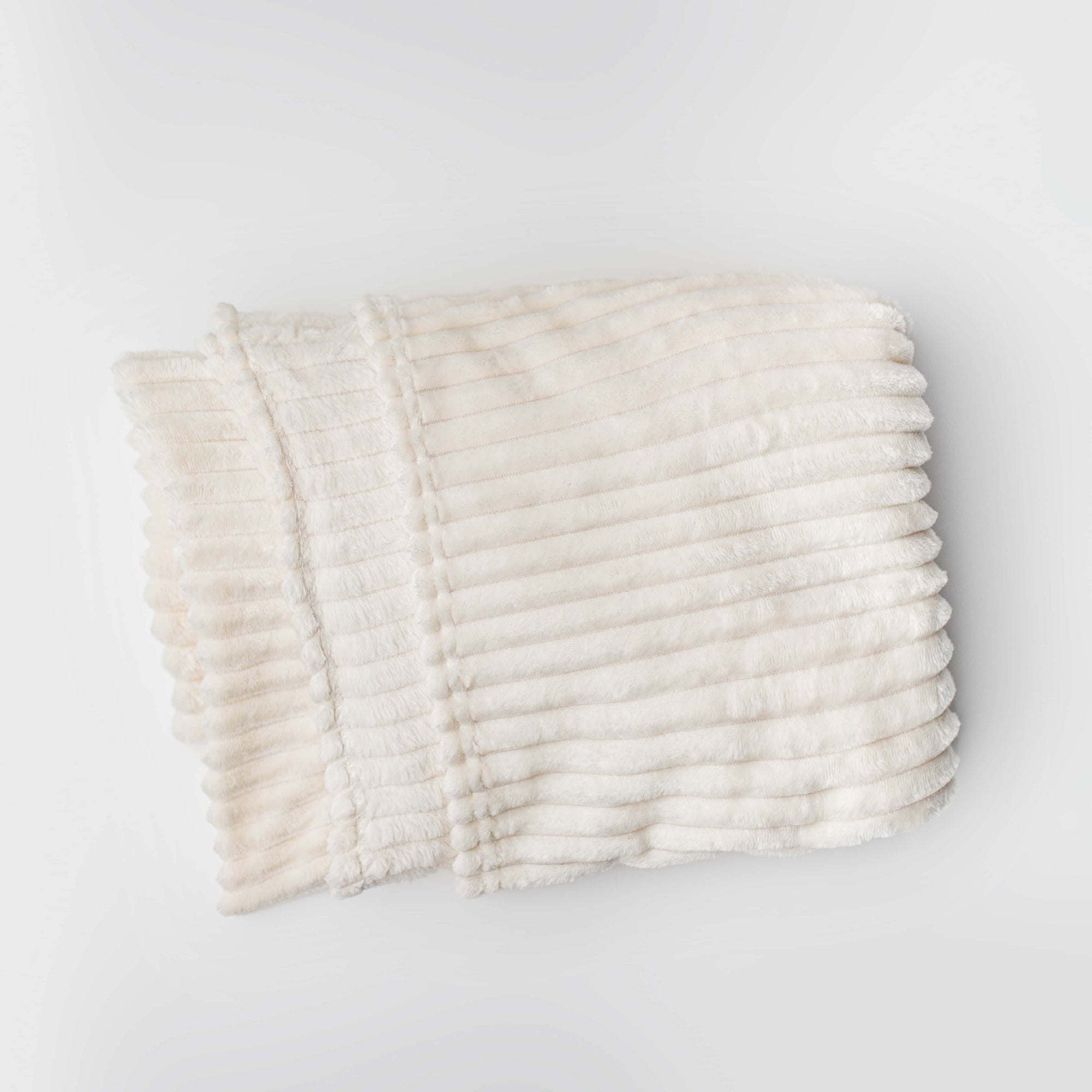 Ivory plush blanket is featured on a white background. 