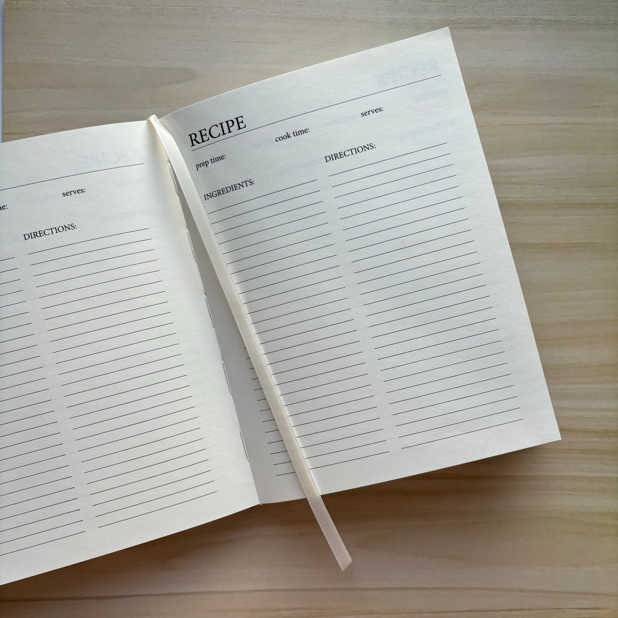 Opened image of green linen recipe book.