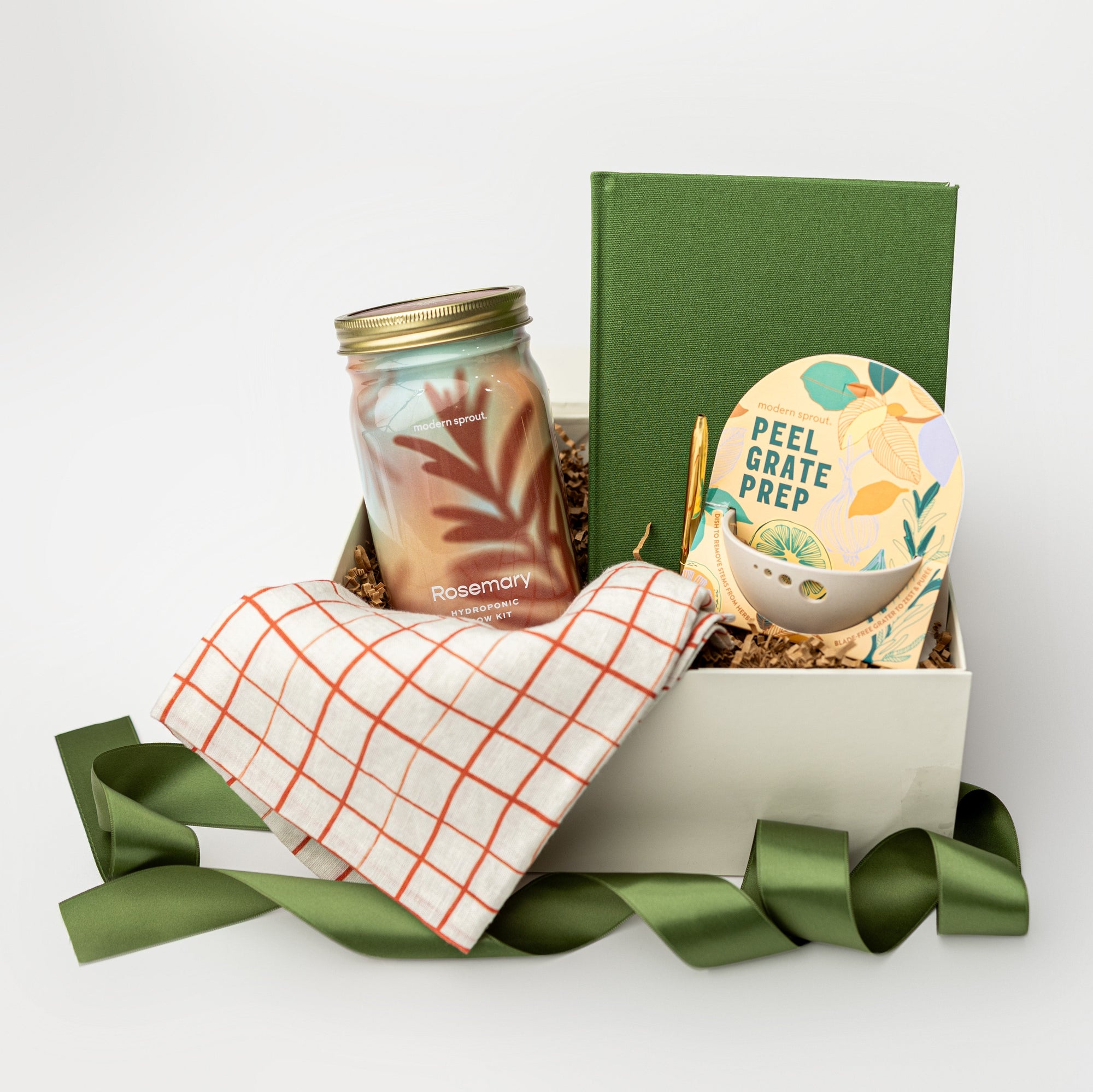 Gift basket with a candle, book, and other items on a white background